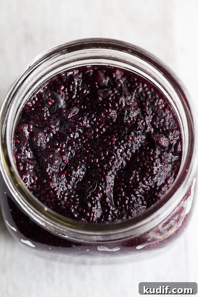 Up-close overhead view of Blueberry Pomegranate Chia Jam in a glass jar.