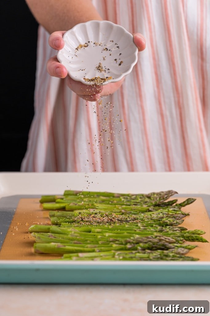 20-Minute Garlic Lemon Asparagus Recipe for Quick Weeknight Sides 6 Adding steak seasoning to asparagus.