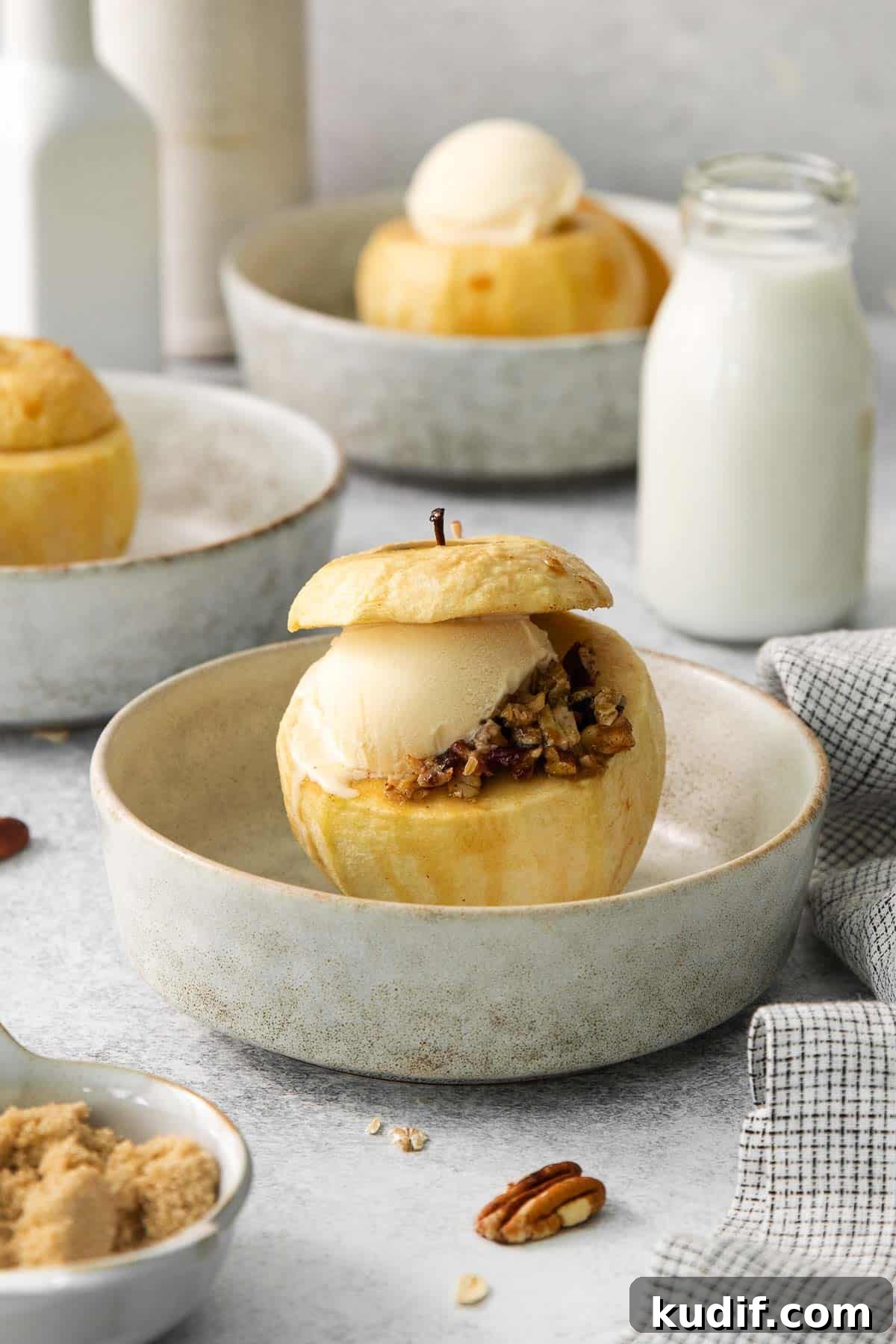 Baked Apples Recipe: Gluten-Free Cinnamon-Stuffed Dessert 6 A baked apple with filling and a scoop of ice cream on a plate