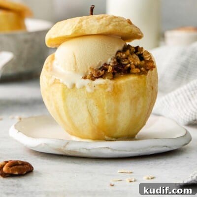 Baked Apples Recipe: Gluten-Free Cinnamon-Stuffed Dessert 7 A baked apple with filling and a scoop of ice cream on a plate