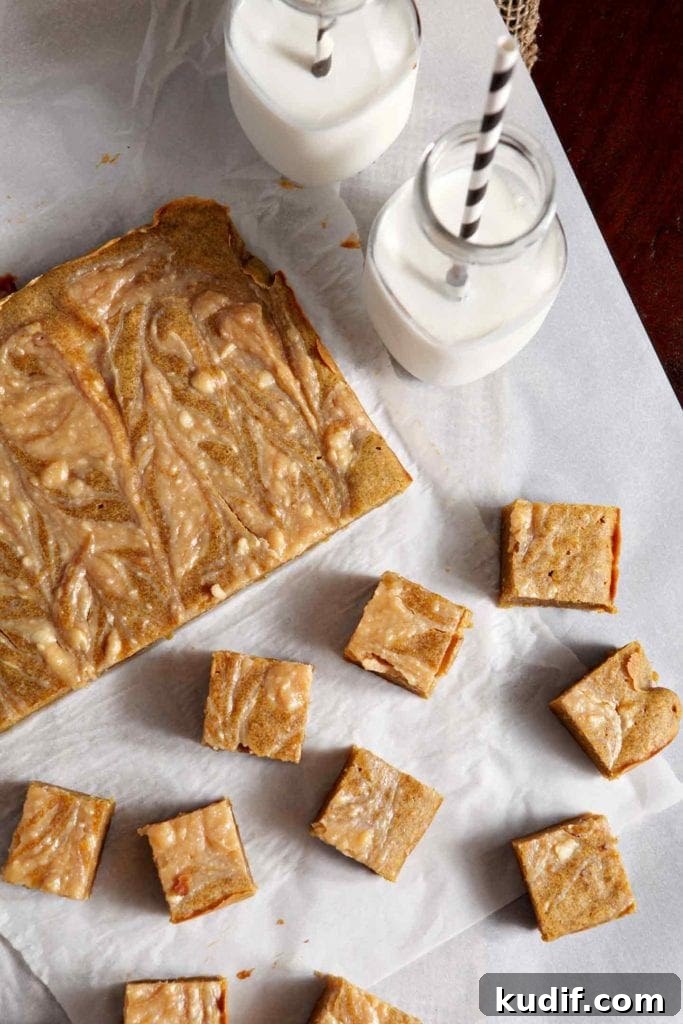 Pumpkin Blondies with Caramel Cream Cheese Swirl Recipe 2 Overhead image of Pumpkin Blondies, partially sliced, and showing the cream cheese caramel swirl