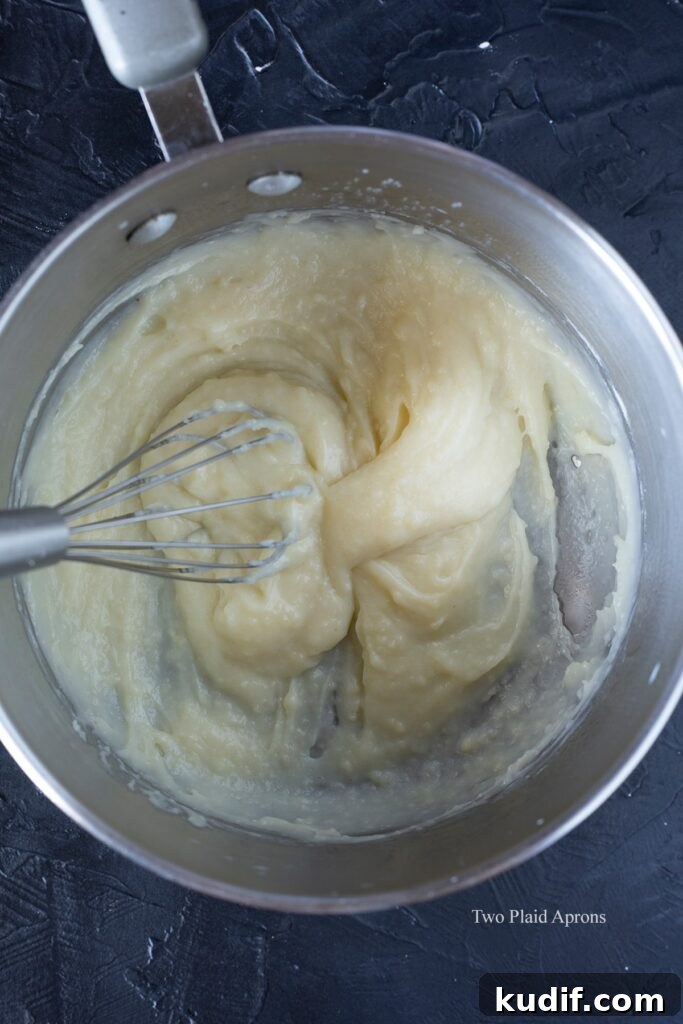 Korean Mochi Bread Recipe: Chewy, Crispy Toasted Rice Cake Guide 5 Showing the consistency of the dough in the saucepan after adding flour.