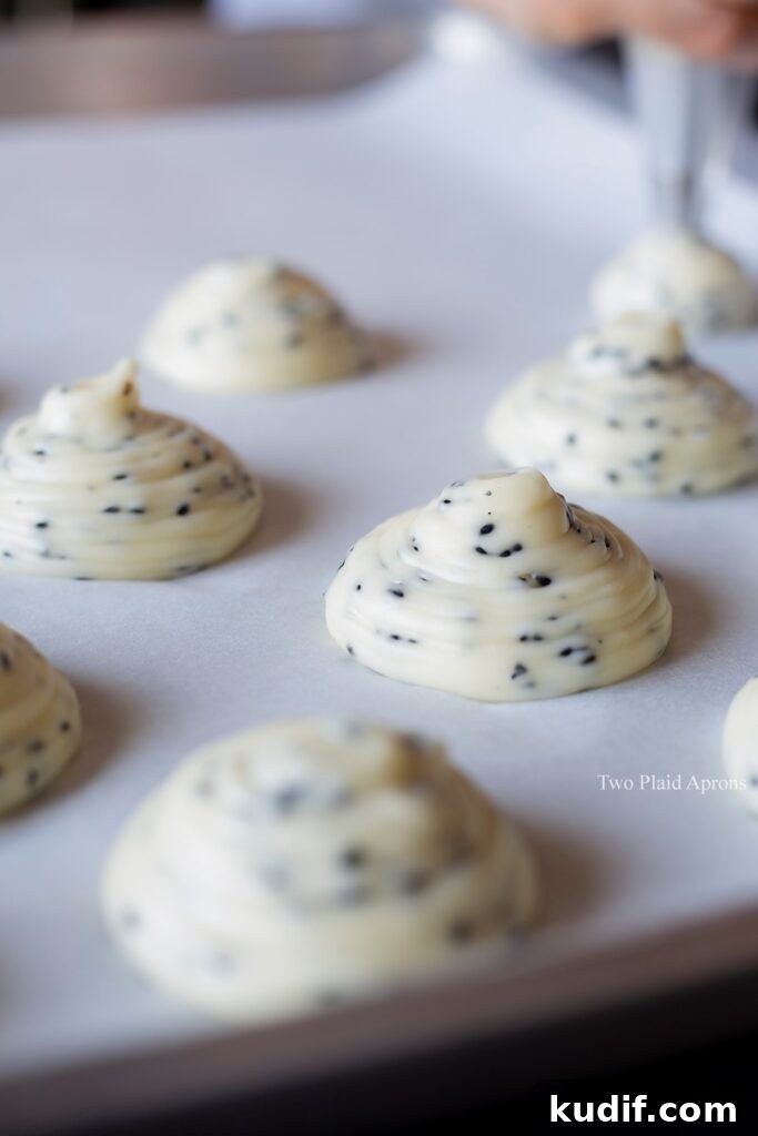 Korean Mochi Bread Recipe: Chewy, Crispy Toasted Rice Cake Guide 8 Piping mounds of the dough on a parchment lined sheet pan.