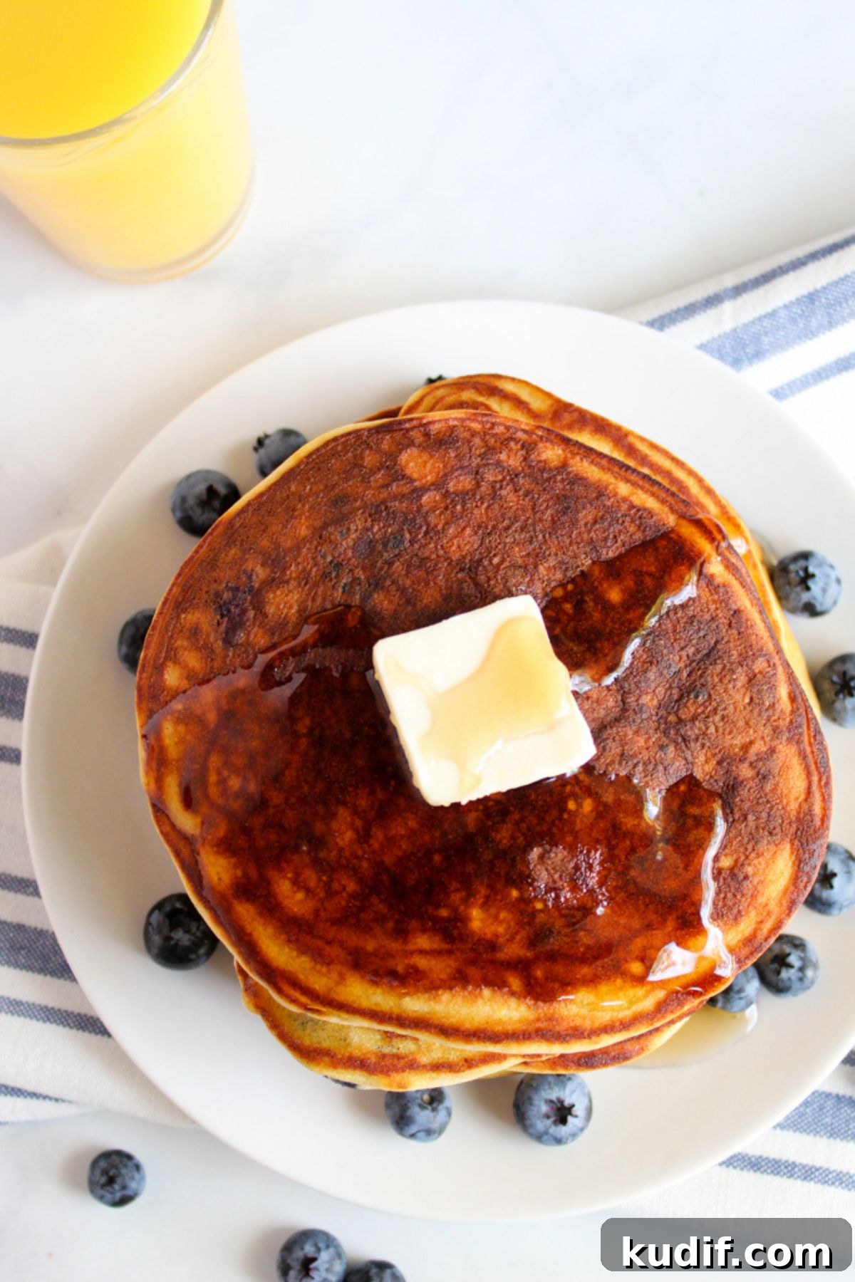 Gluten-Free Blueberry Pancake Recipe That Flips Perfectly 4 stack of pancakes with pat of butter on top
