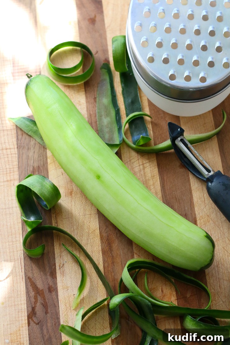 Use a vegetable peeler to peel the cucumber and then shred using a coarse cheese grater.