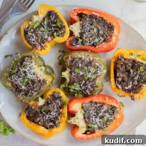 Smoky Black Bean Stuffed Peppers with Cilantro Lime Rice 15 Serving platter with colorful black bean stuffed peppers.