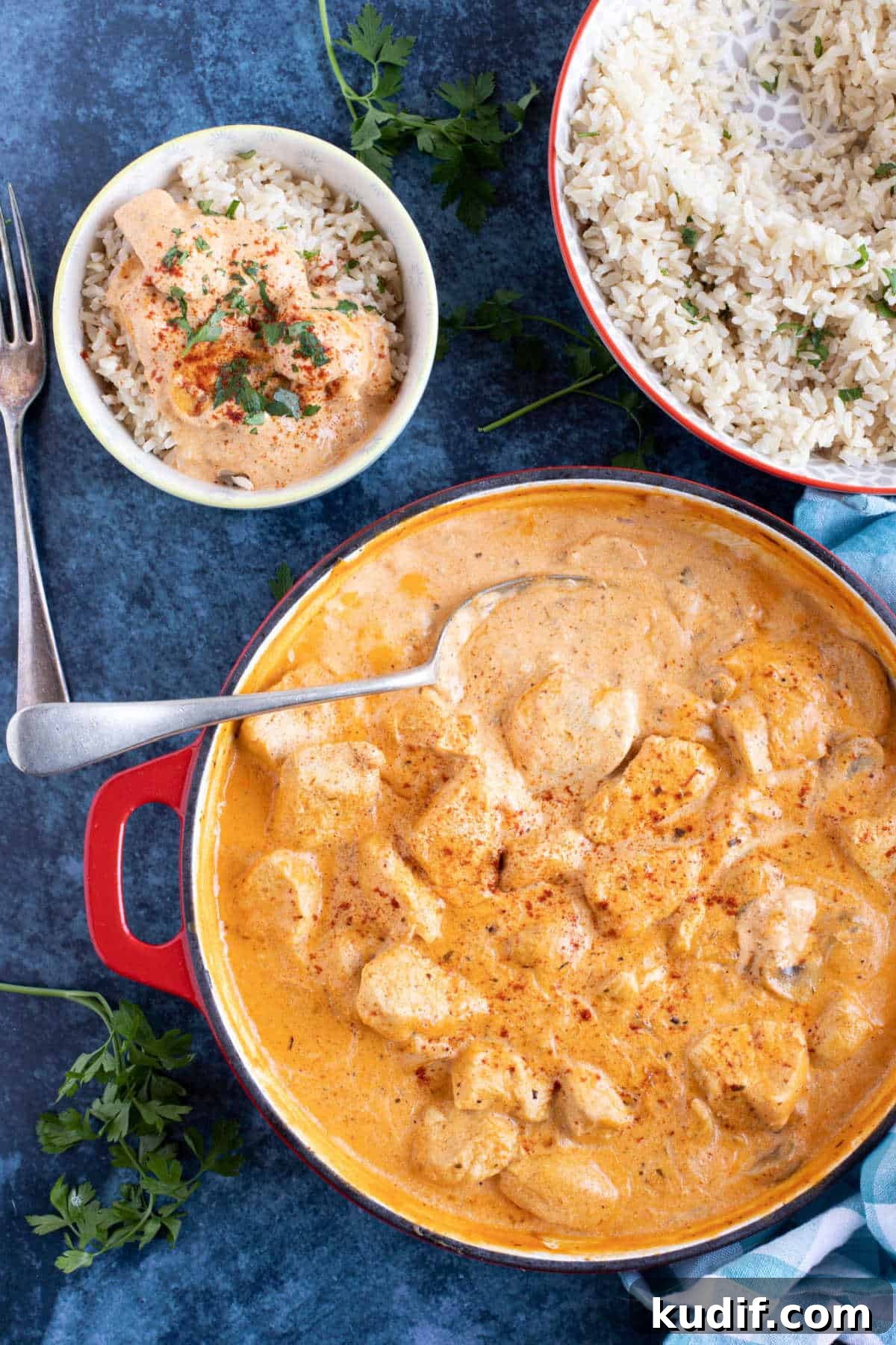 Creamy Chicken and Mushroom Stroganoff Recipe 4 Chicken and mushroom stroganoff in a pan with a bowl of stroganoff and rice on the side.