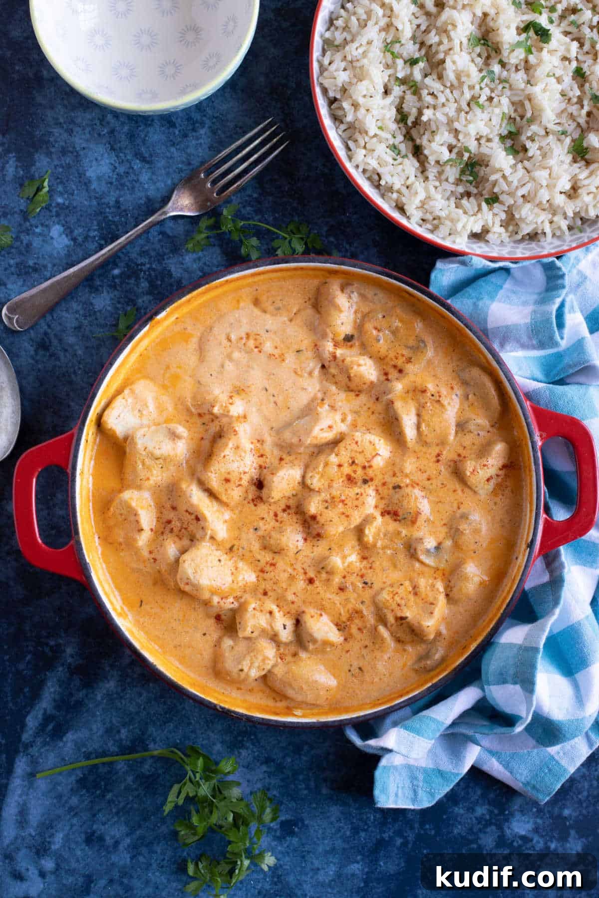 Creamy Chicken and Mushroom Stroganoff Recipe 5 Chicken and mushroom stroganoff in a red pan with a side of rice.