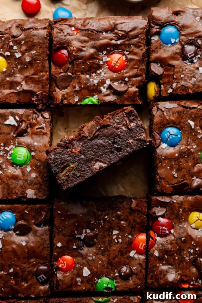 A close-up on the sliced brownies, with one facing towards the camera to show the fudgy insides.