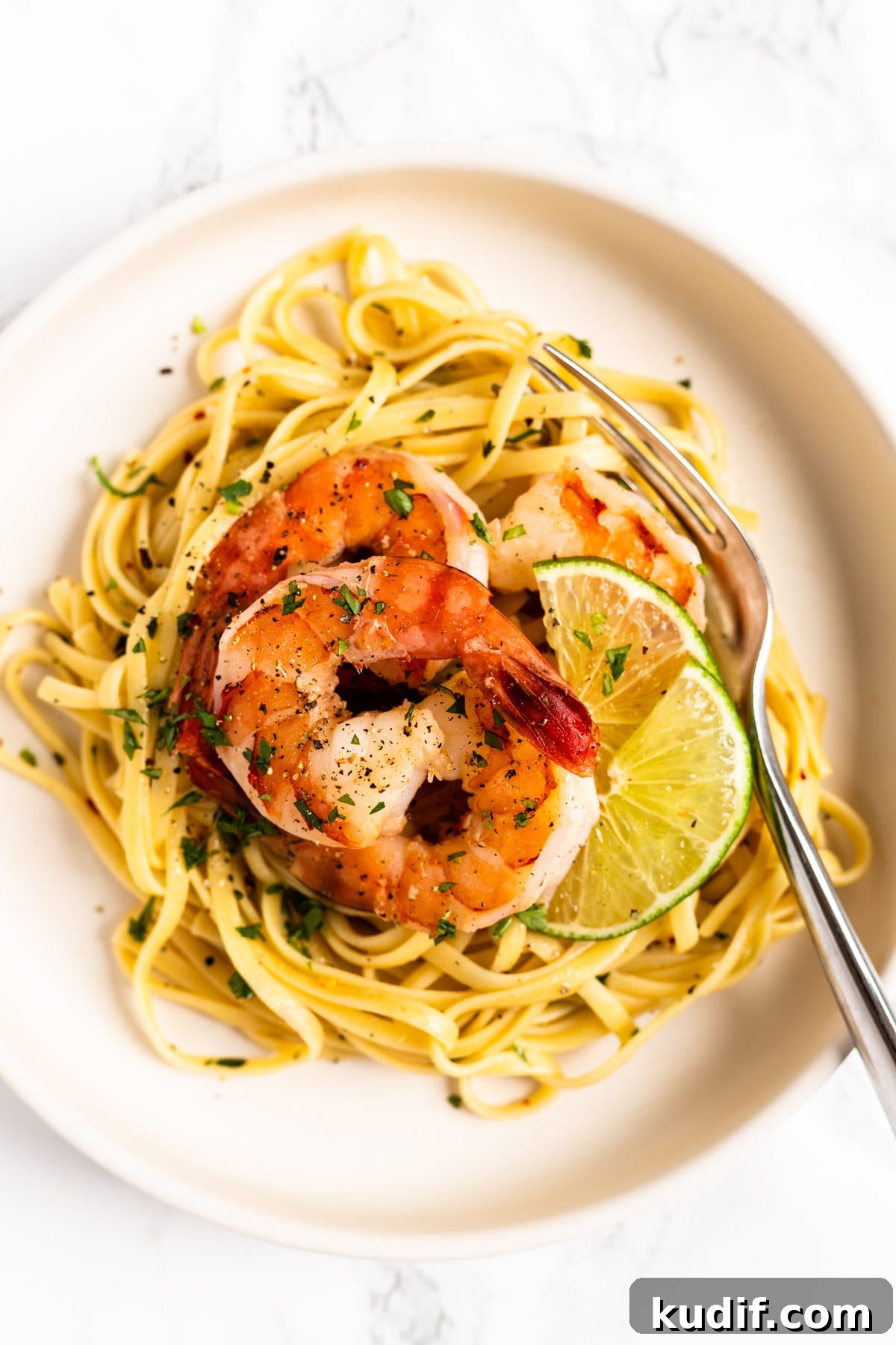 Cilantro-Lime Shrimp Pasta with Garlic and Parmesan 2 A top down view of a bowl of cilantro lime shrimp pasta.