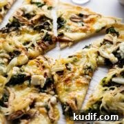 wild mushroom pizza sliced and served on a plate