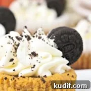 oreo pumpkin cheesecake made in mini pans and garnished with oreos