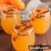 apple cider spiked with alcohol and garnished with star anise and cinnamon stick
