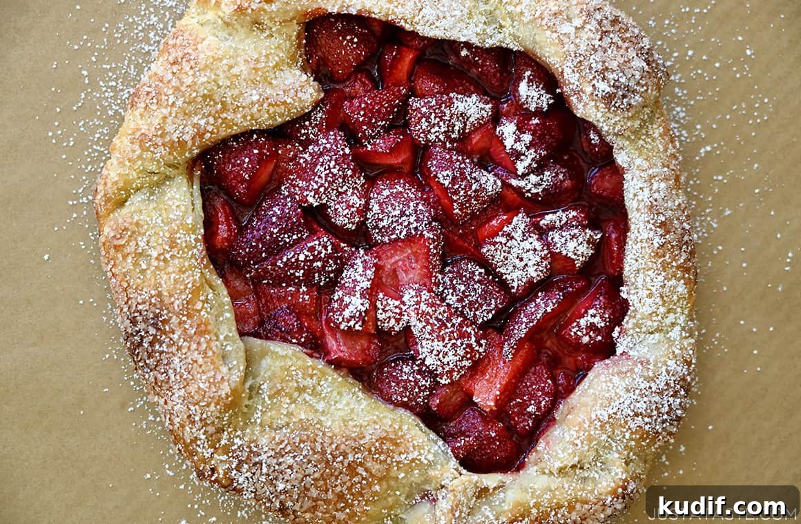Puff Pastry Galette Recipe: Step-by-Step Fruit and Savory Ideas 6 A top-down view of a golden brown galette made with puff pastry and fresh strawberries