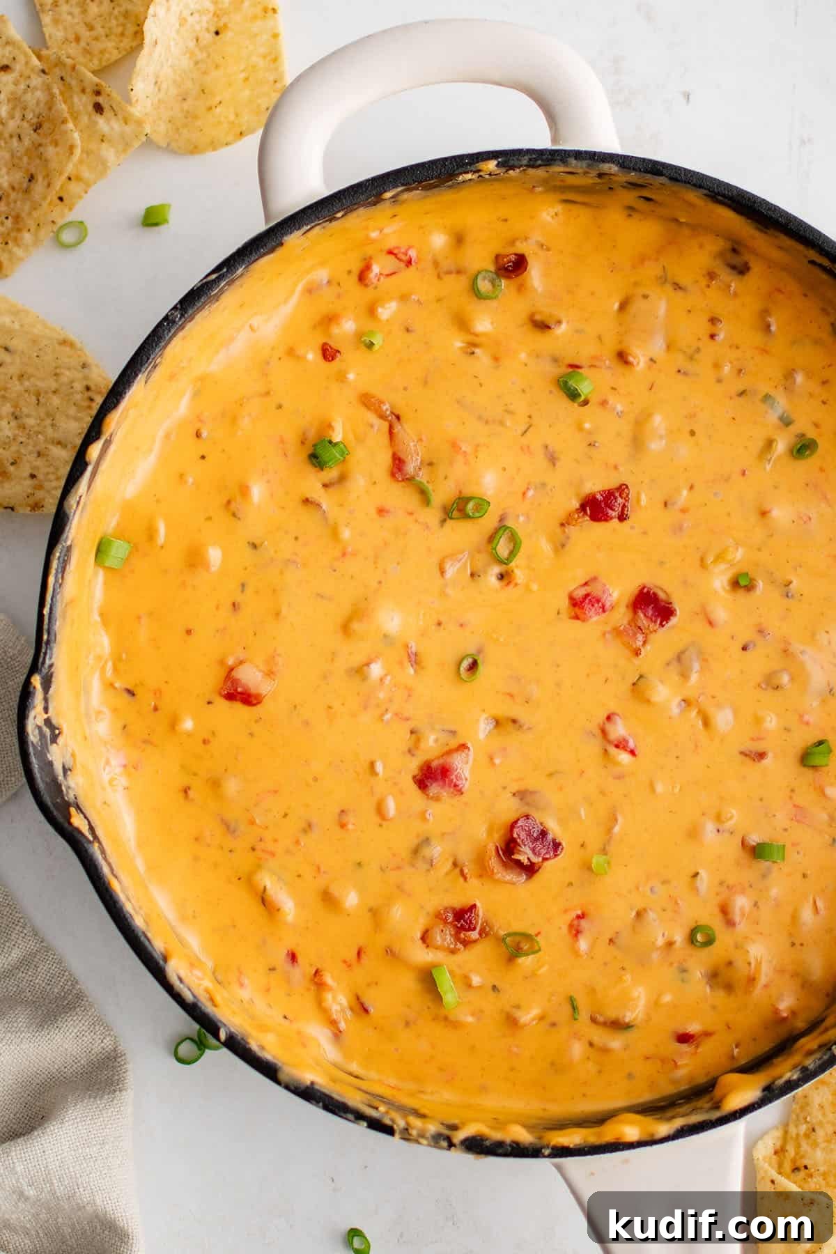 Easy Bacon Cheese Dip is a mouthwatering one pan cheese dip recipe that always gets rave reviews! This gooey cheese dip is packed full of velveeta, cheddar, bacon, diced tomatoes and green chilis, and ranch seasoning! bacon cheese dip in a pan