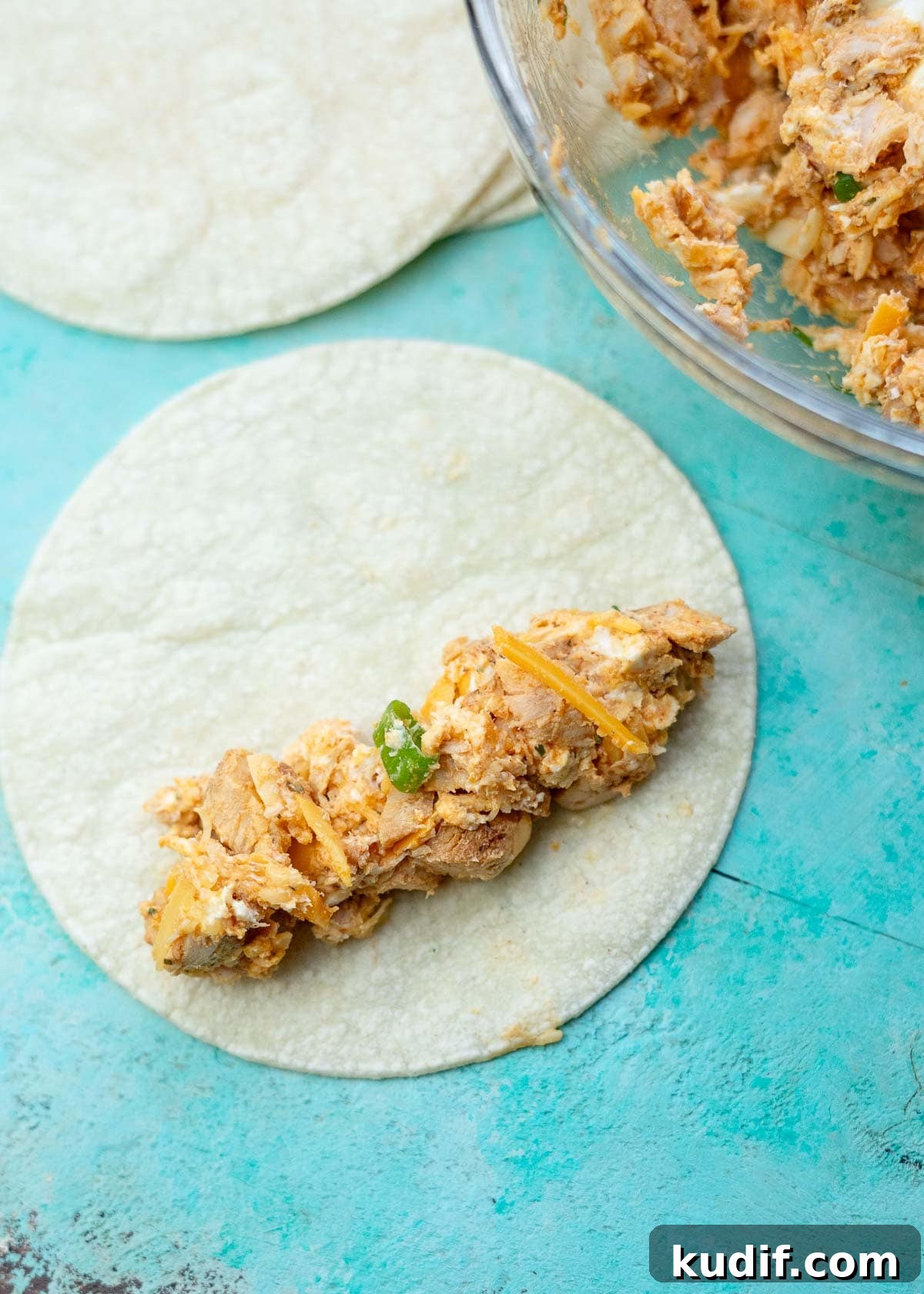 Spicy Buffalo Chicken Taquitos Recipe for Game Day Snacks 6 two tablespoons of cheesy buffalo chicken mixture on a warm corn tortilla