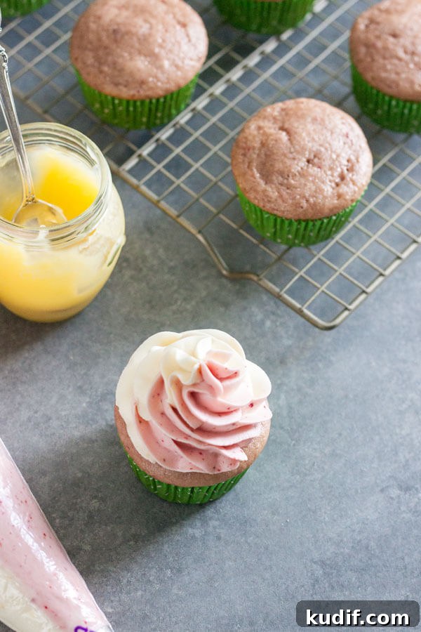 Frosting is added to the filled cupcake to cover up the hole and extra piece of cupcake sticking out