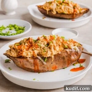Buffalo Chicken Stuffed Sweet Potatoes Recipe for Spicy Weeknight Meals 9 Buffalo chicken sweet potato boats in the slow cooker, topped with shredded cheese and chives.