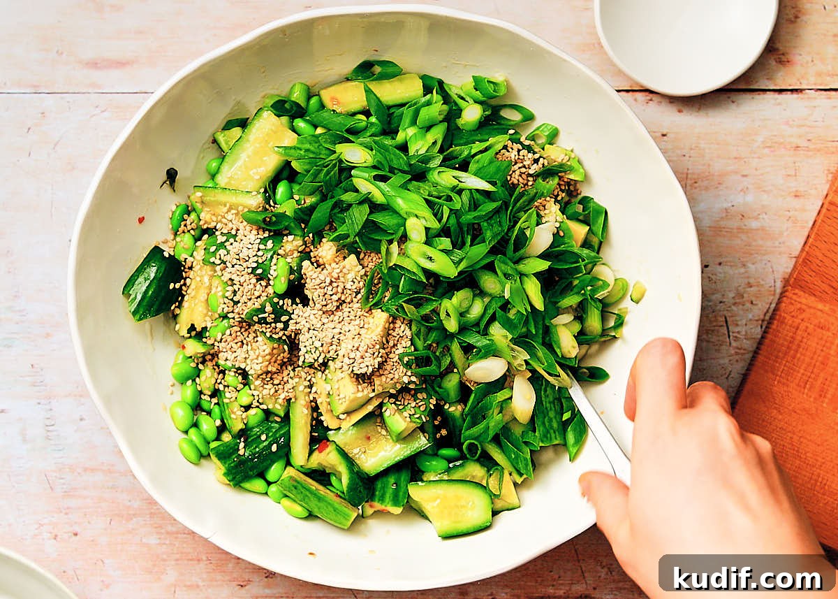 Spicy Cucumber Salad Recipe: Quick Tangy Side Dish 11 Stirring together all the Spicy Cucumber Salad ingredients in a serving bowl.