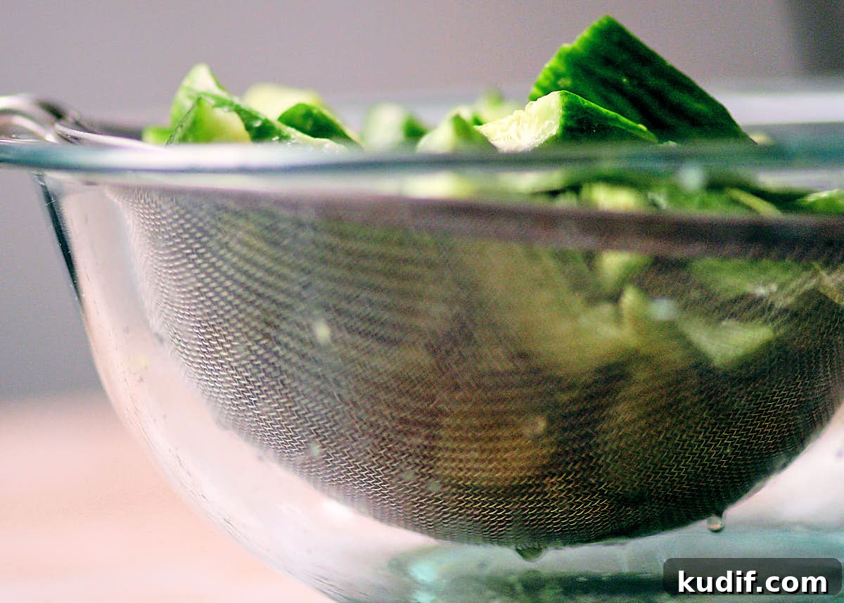 Spicy Cucumber Salad Recipe: Quick Tangy Side Dish 8 Salted cucumbers in a mesh sieve to drain extra water away.
