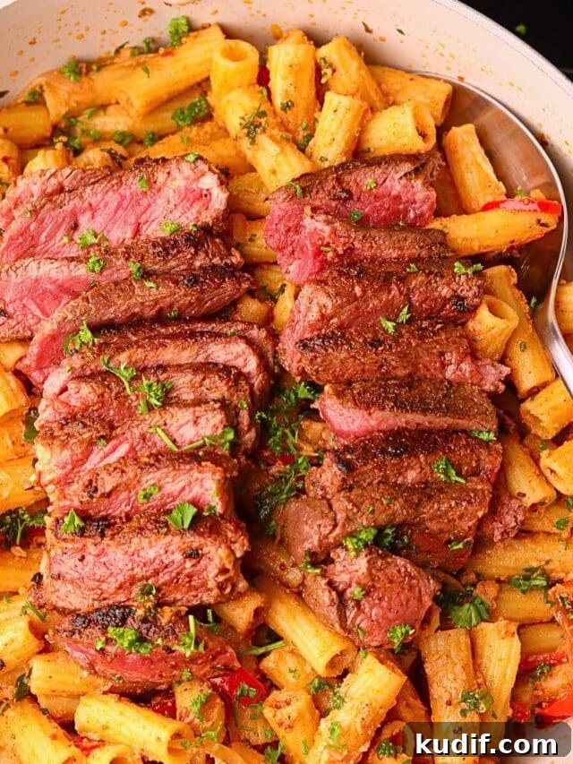Cowboy butter steak rigatoni in a skillet.