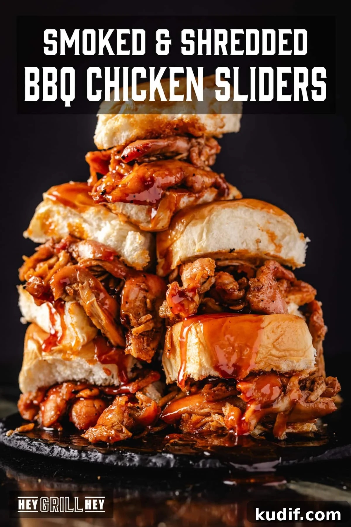 Chicken sliders stacked on a black plate. The Text overlay reads 'Smoked & Shredded BBQ Chicken Sliders' at the top, and 'Hey Grill Hey' at the bottom.