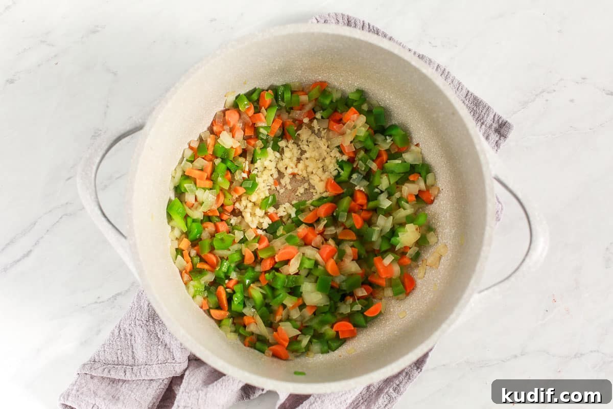 Hearty Chicken and Vegetable Soup Recipe for Cozy Weeknights 4 uncooked vegetables in a soup pot