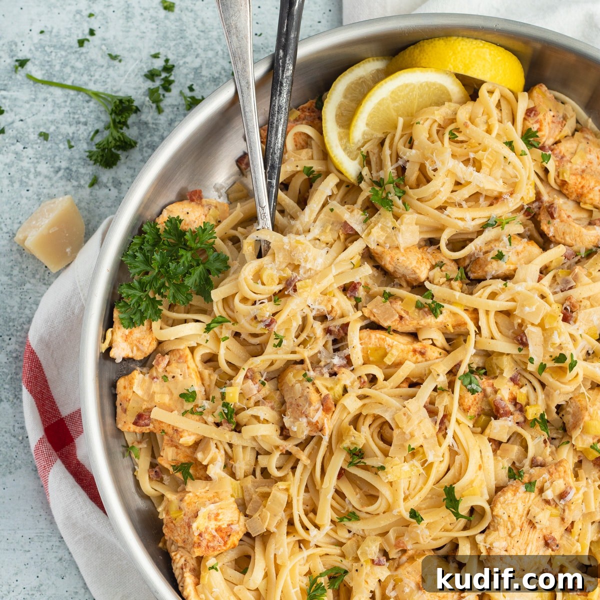 This is a square picture of a skillet filled with chicken and leek pasta.