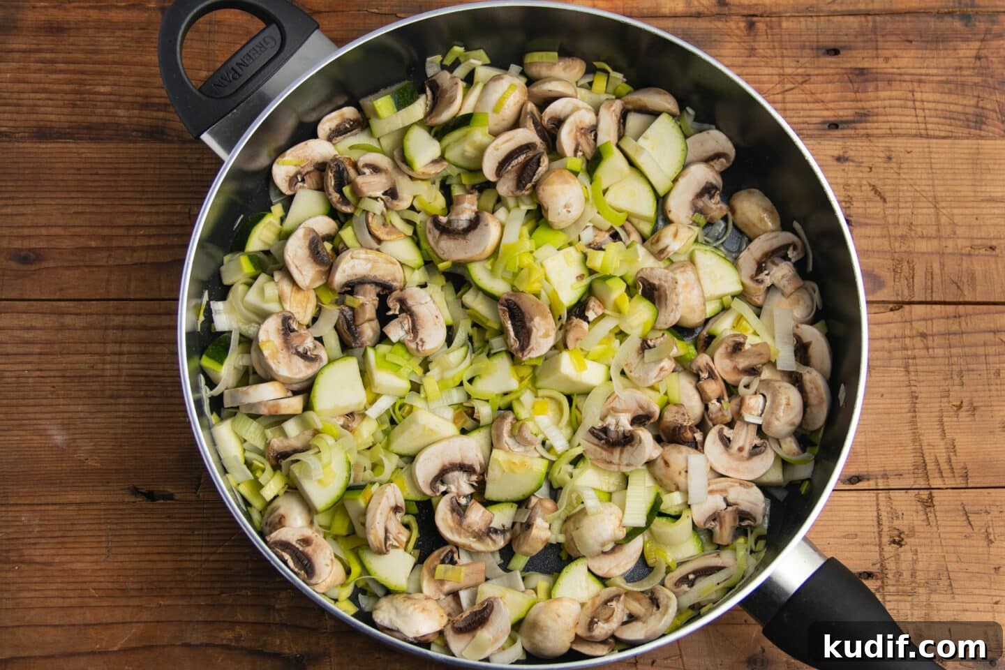 Zucchini, Mushroom & Leek Pasta Recipe — Creamy Spring Pasta 5 This is a picture of the vegetables being sautéed in a large skillet.