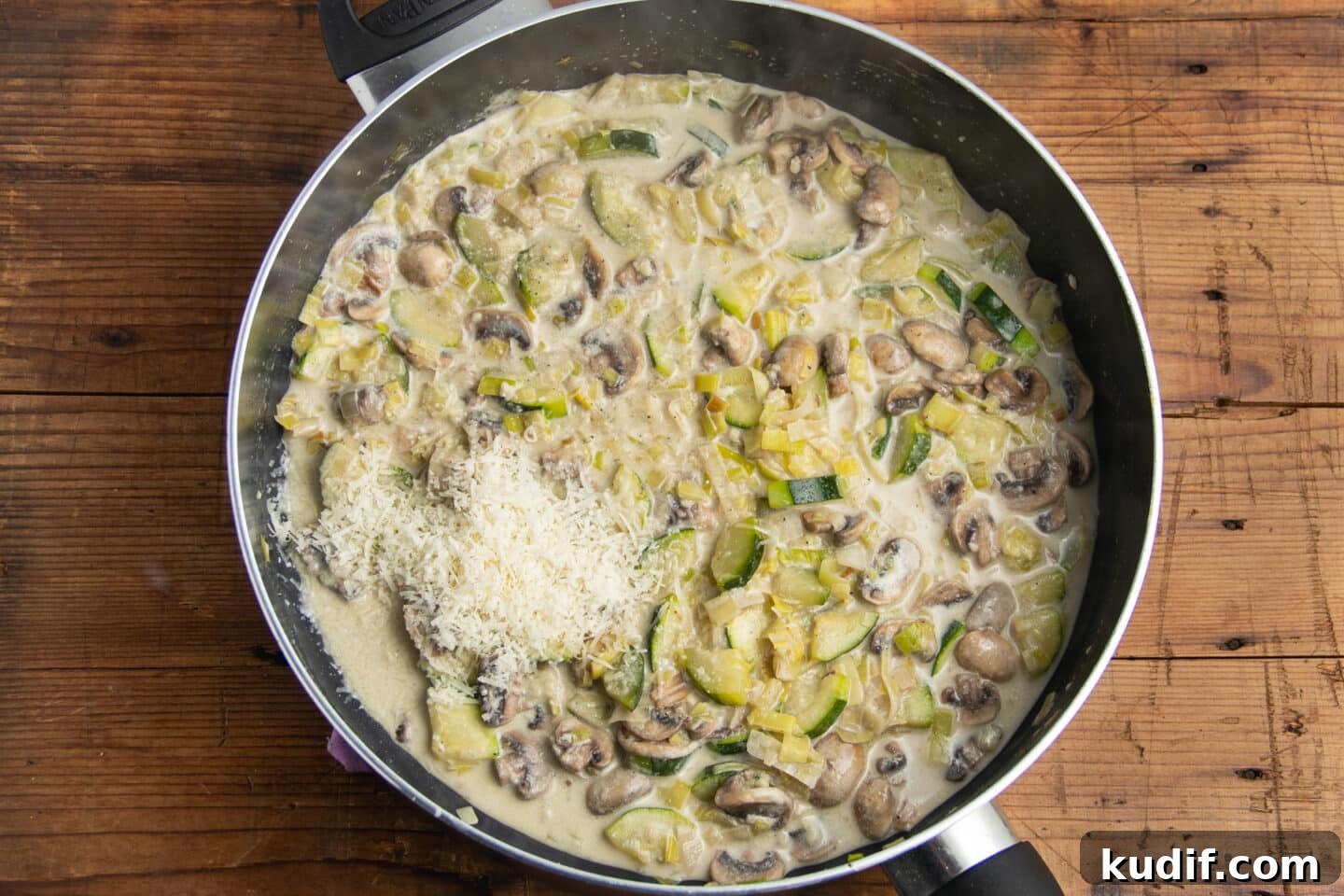 Zucchini, Mushroom & Leek Pasta Recipe — Creamy Spring Pasta 9 This is a picture of the skillet with the parmesan and pasta water added.