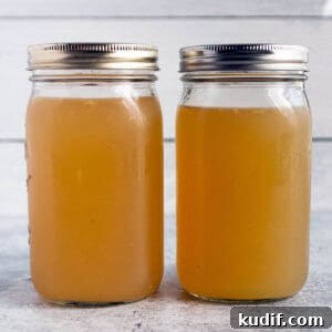 Nourishing Turkey Bone Broth Recipe for Deep Flavor and Gelatin 9 Two large mason jars with a homemade turkey broth and lids on top.