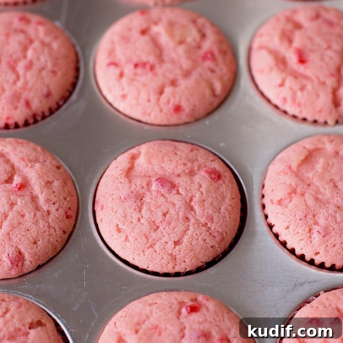Cherry Almond Cupcakes with Cherry Glaze and Almond Crunch 4 Cherry almond cupcakes in muffin tin.