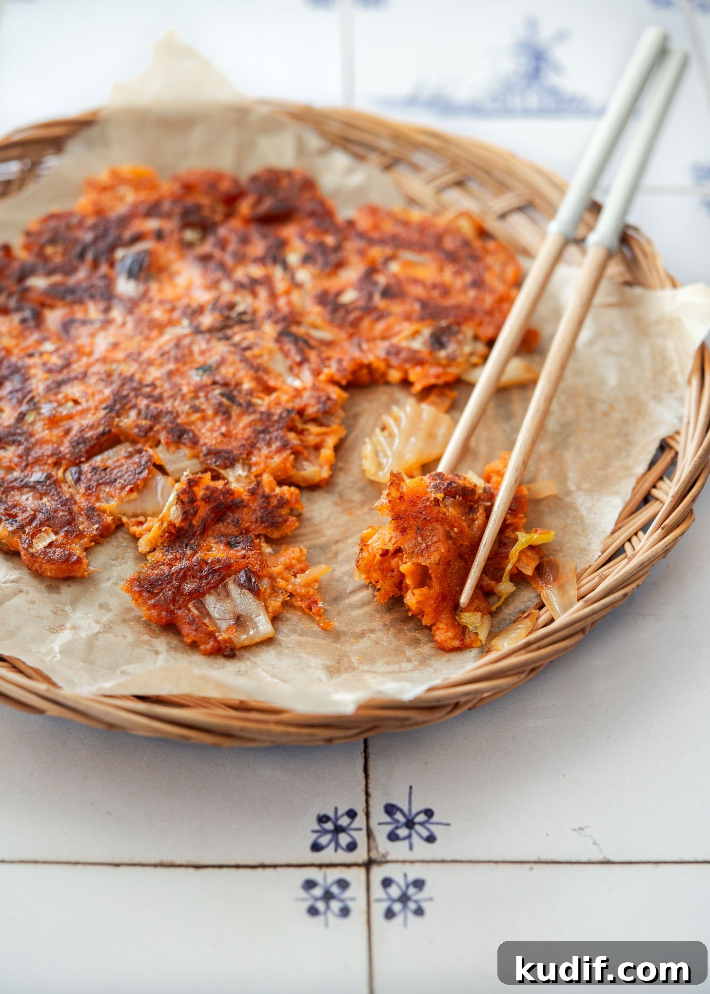 Crispy Kimchi Pancakes (Kimchi Jeon) Recipe for Perfect Pan-Fried Kimchi Cakes 4 Piece of crispy kimchi pancake (kimchi jeon) picked up with chopsticks