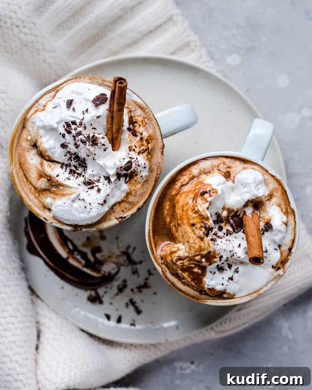 Vegan Gingerbread Hot Chocolate Recipe for Cozy Winter Nights 2 Overhead view of hot chocolate in two white mugs on a white plate.