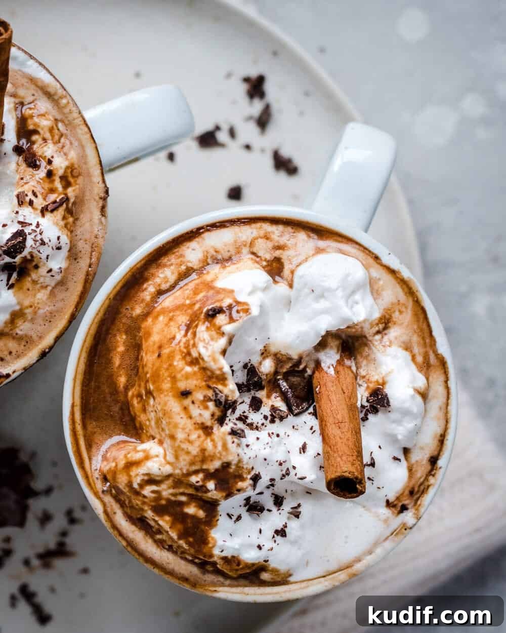 Vegan Gingerbread Hot Chocolate Recipe for Cozy Winter Nights 4 Close up overhead view of hot chocolate in a white mug on a white plate.