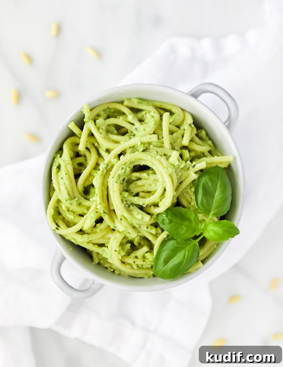 Creamy Pesto Sauce Recipe: Rich Basil Sauce for Pasta & More 4 An overhead shot of creamy pesto over spaghetti, garnished with basil leaves