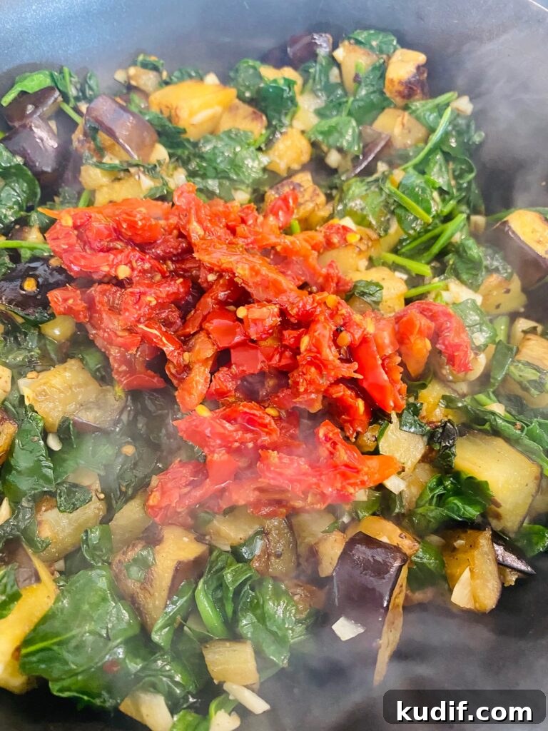 Mediterranean Quinoa Bowls with Fresh Veggies & Lemon Tahini 6 adding the sun dried tomatoes
