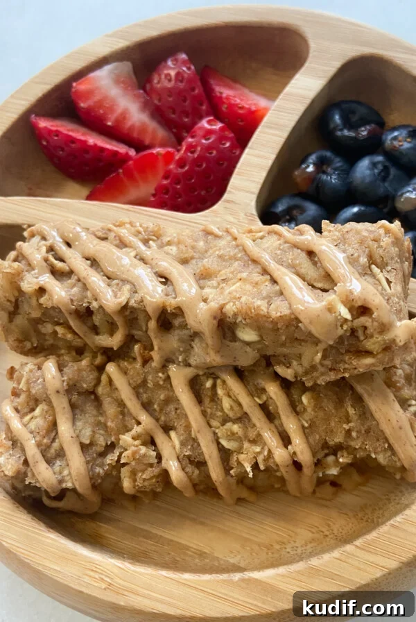 Healthy apple oatmeal bars served with berries