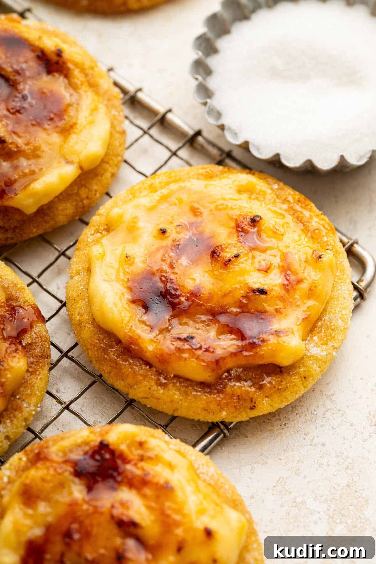 Crème Brûlée Cookie Recipe: Crispy Edges, Gooey Center 2 Torched creme brulee cookies on a wire rack.
