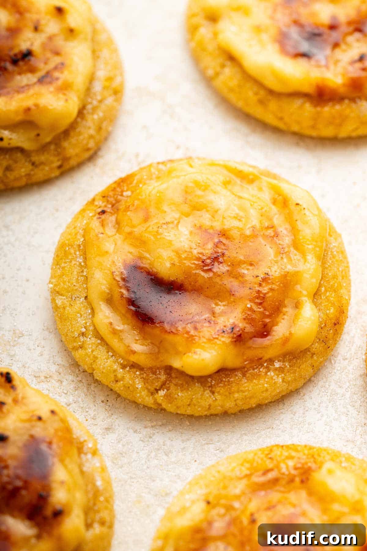 Crème Brûlée Cookie Recipe: Crispy Edges, Gooey Center 13 Macro shot of creme brulee sugar cookies on white surface.
