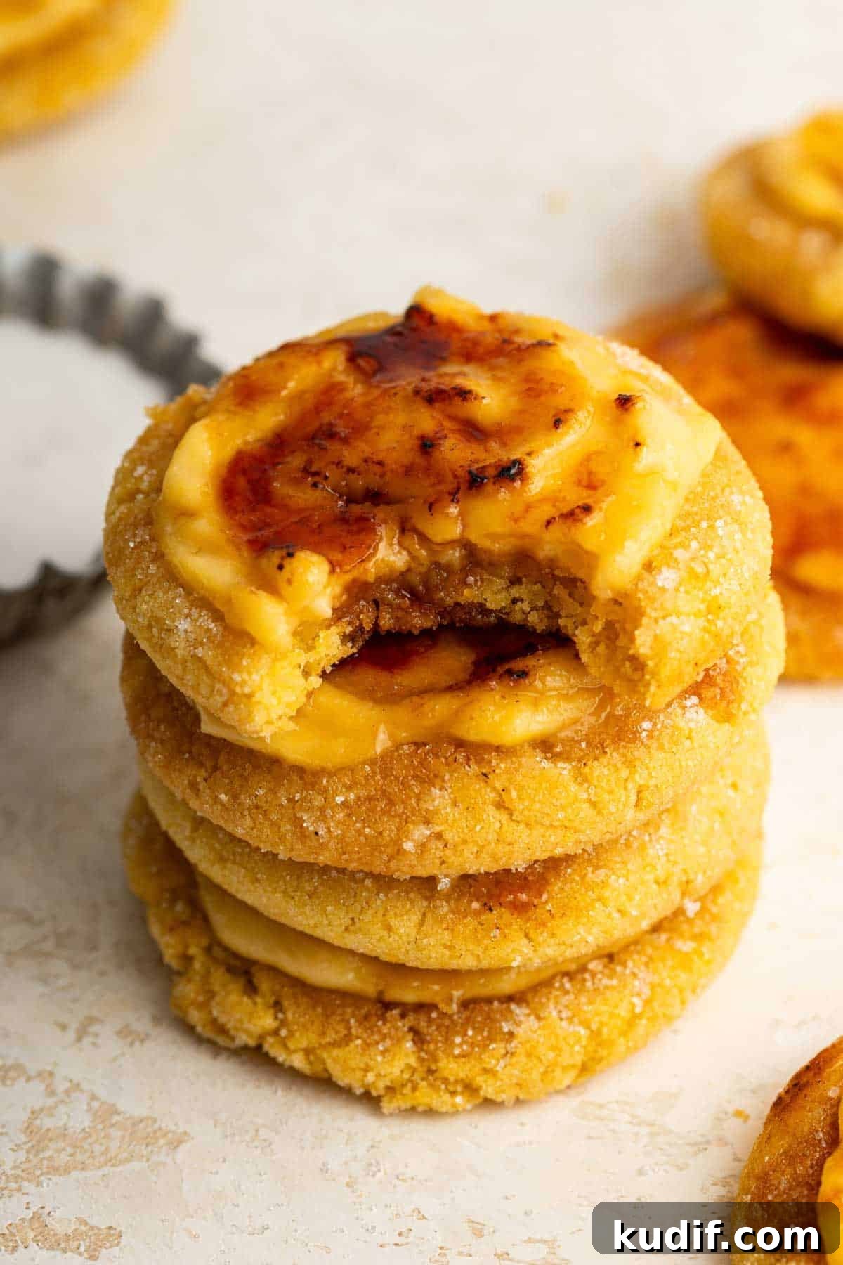 Crème Brûlée Cookie Recipe: Crispy Edges, Gooey Center 3 Stack of creme brulee cookies with bite missing from top cookie.