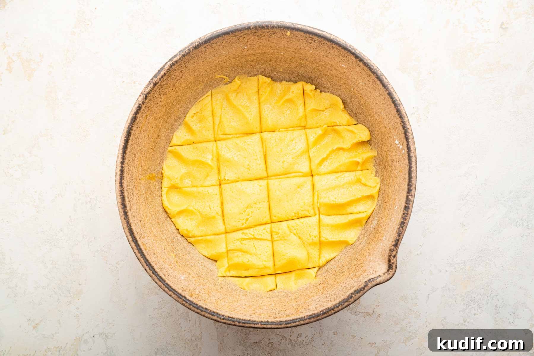 Crème Brûlée Cookie Recipe: Crispy Edges, Gooey Center 7 Yellow dough scored in a bowl into 12 servings.