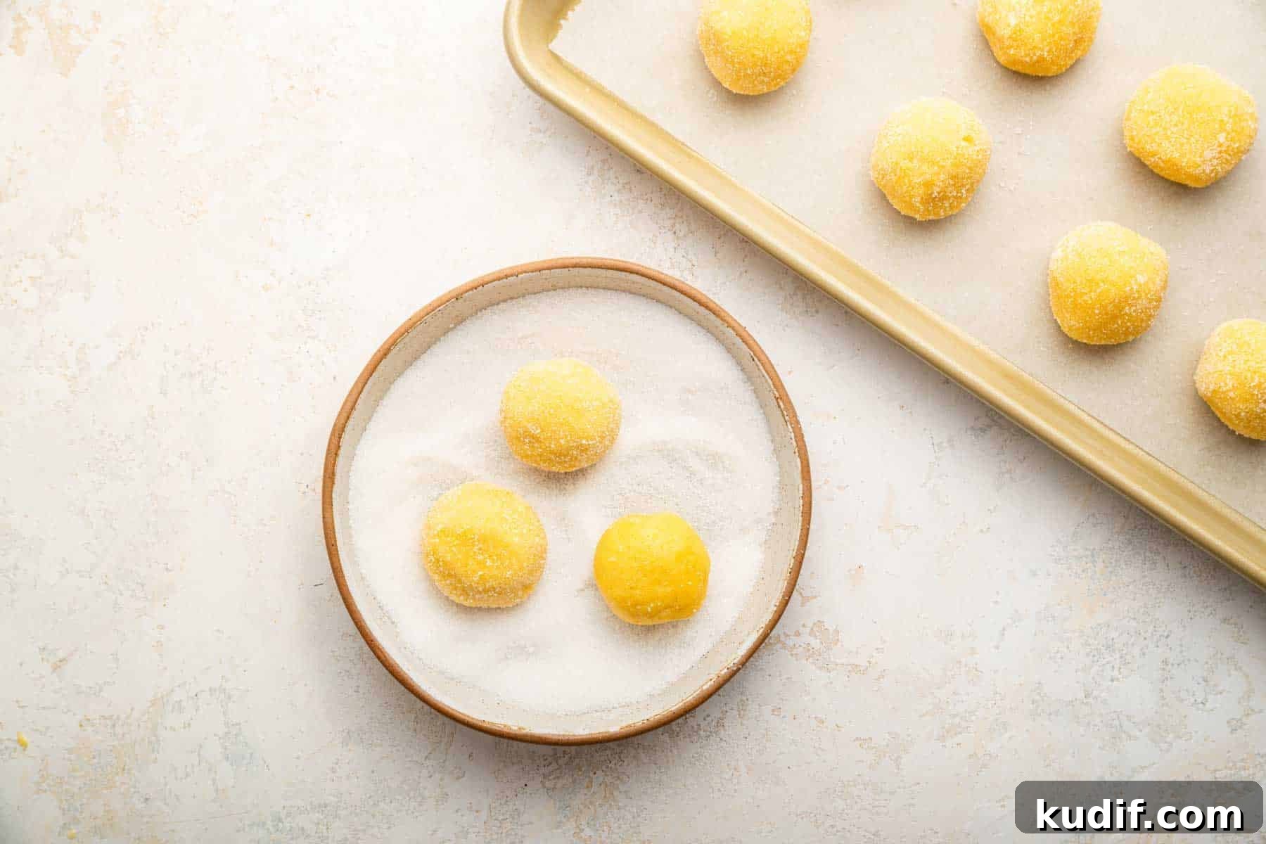 Crème Brûlée Cookie Recipe: Crispy Edges, Gooey Center 8 Three yellow dough balls rolling in sugar.