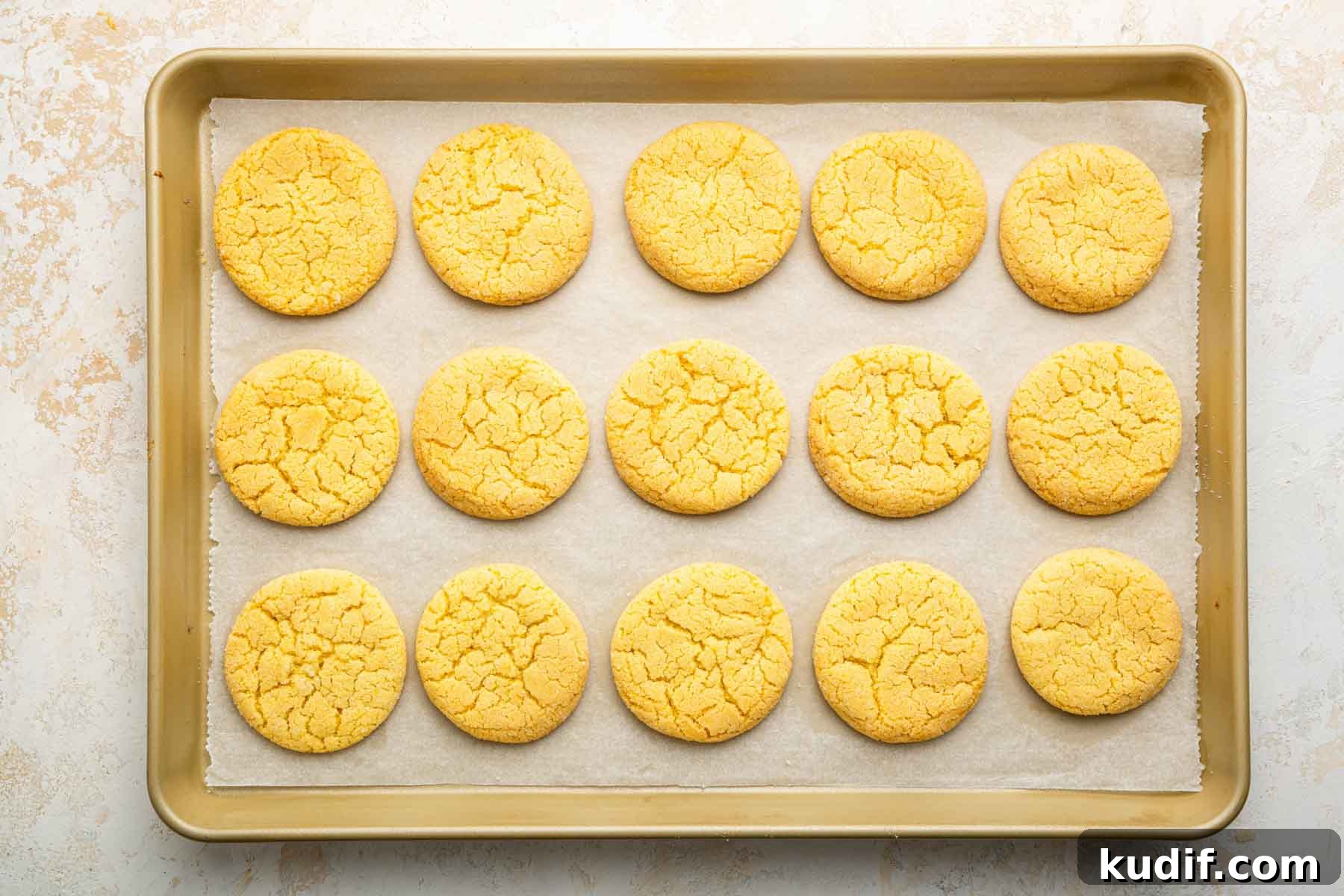 Crème Brûlée Cookie Recipe: Crispy Edges, Gooey Center 9 Horizontal image of freshly baked yellow cookies on a baking sheet.