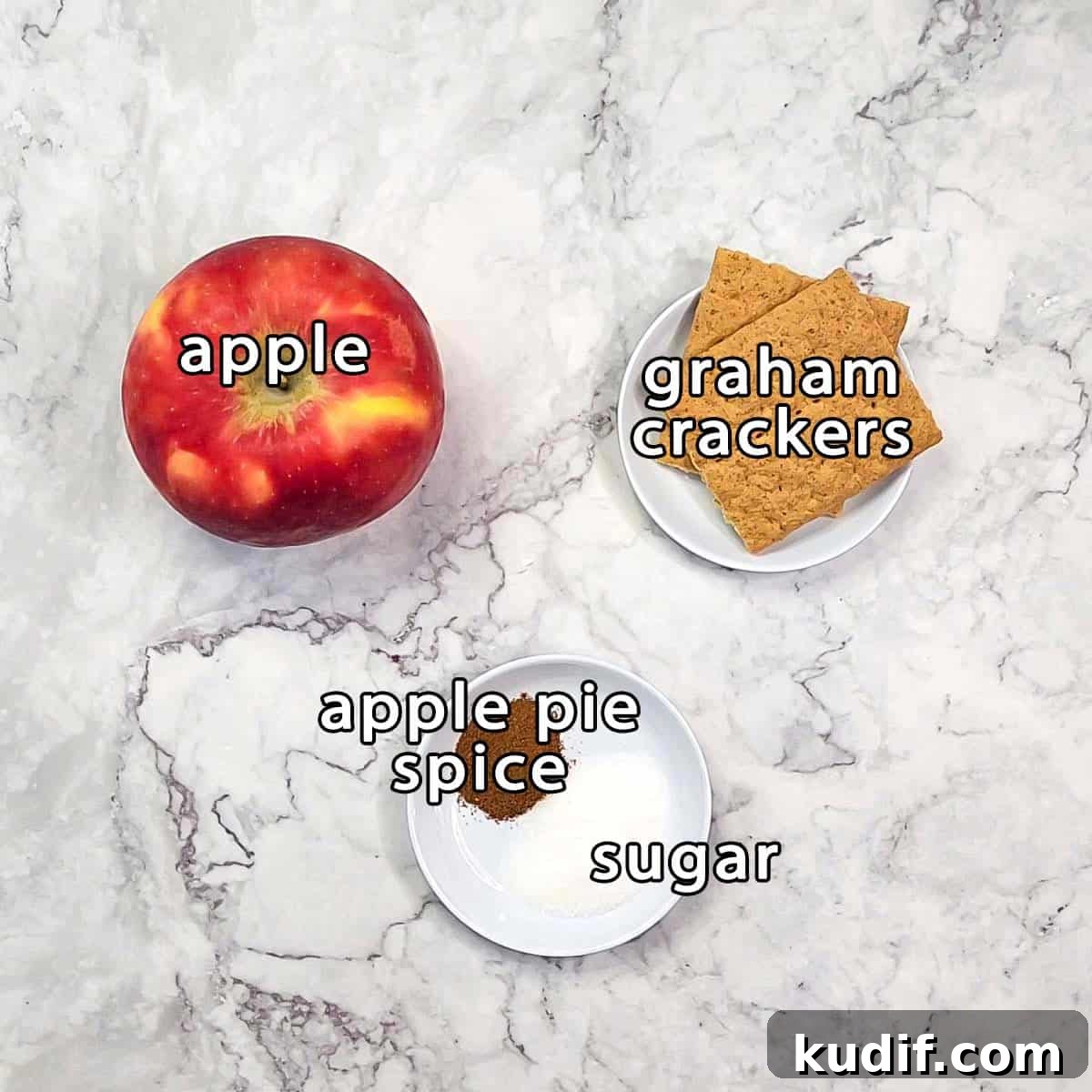 Overhead shot of ingredients - apple, graham crackers, apple pie spice, and sugar.