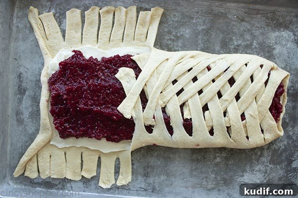 Raspberry Crescent Danish: Flaky Pastry Recipe for Brunch 13 braiding crescent roll dough over cream cheese and raspberry filling