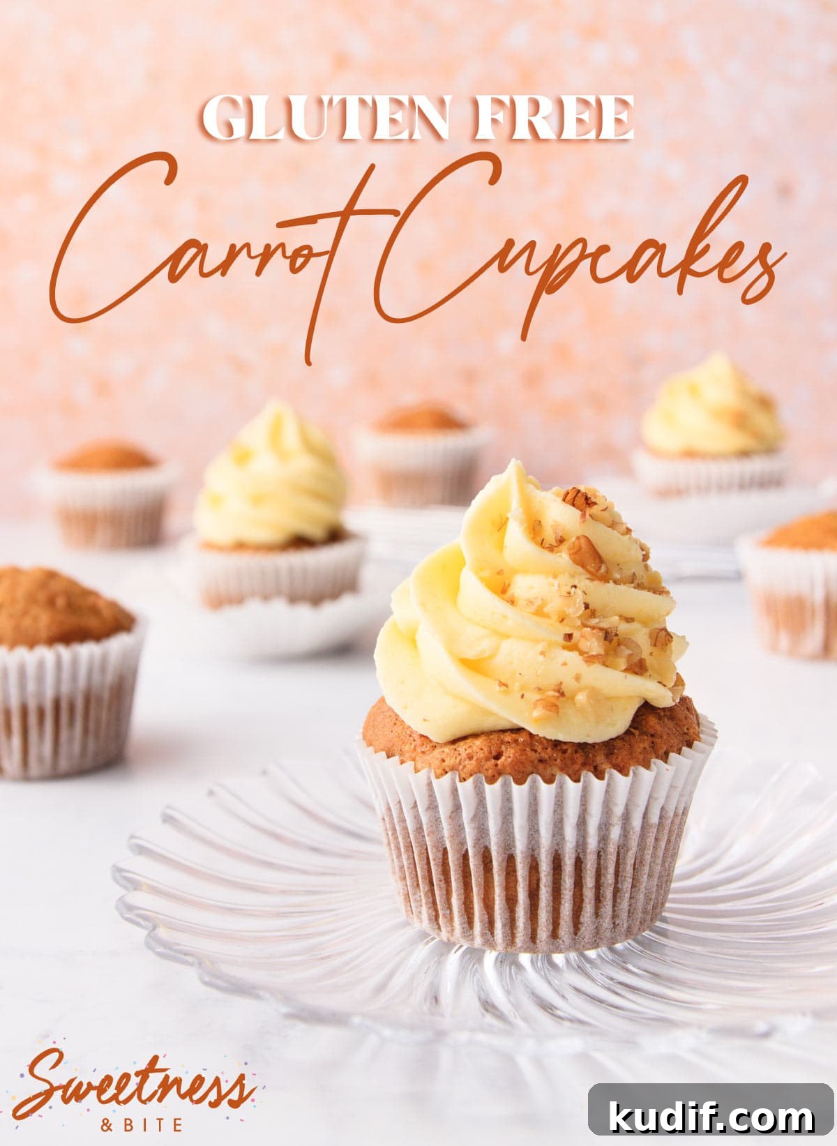 A gluten free carrot cake cupcake with cream cheese frosting on a glass plate, with other cupcakes in the background.