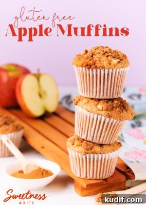 Three muffins stacked on top of each other, on a wooden board, with an apple and small dish of cinnamon in the background, text overlay reads "gluten free apple muffins".