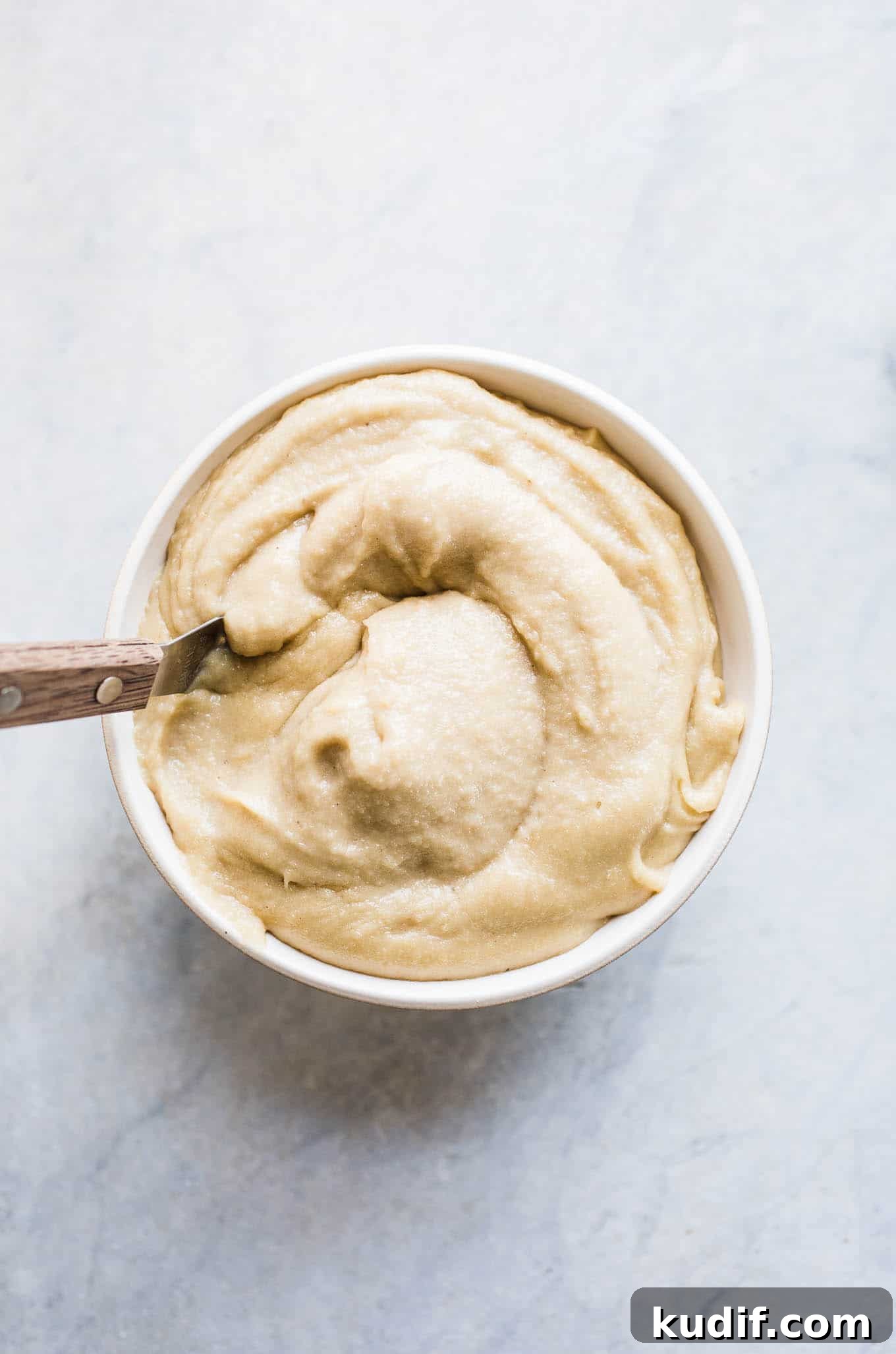 Gluten-Free Vegan Carrot and Zucchini Cake Recipe 3 A bowl full of cashew cream frosting.