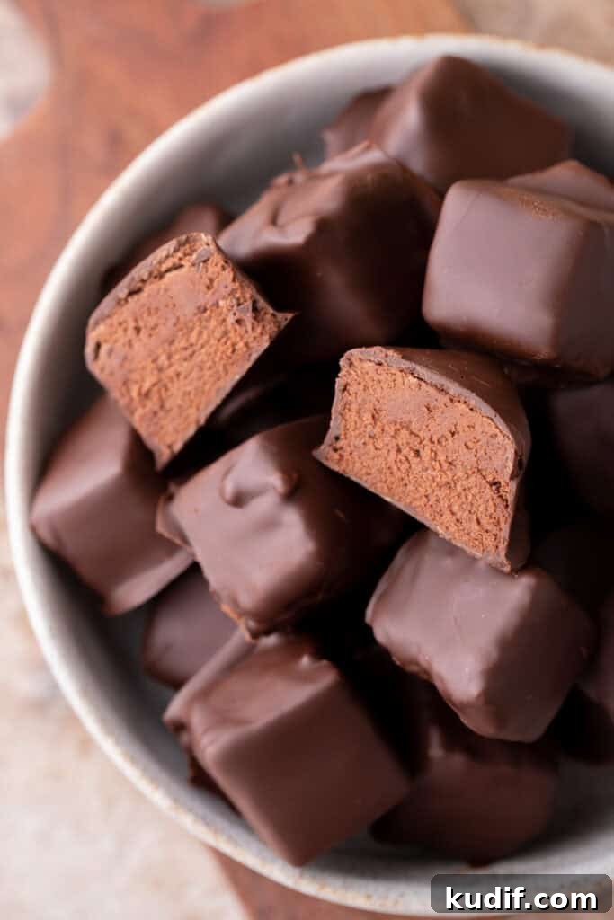 Bowl of homemade cool whip candy with smooth chocolate coating and soft centers.